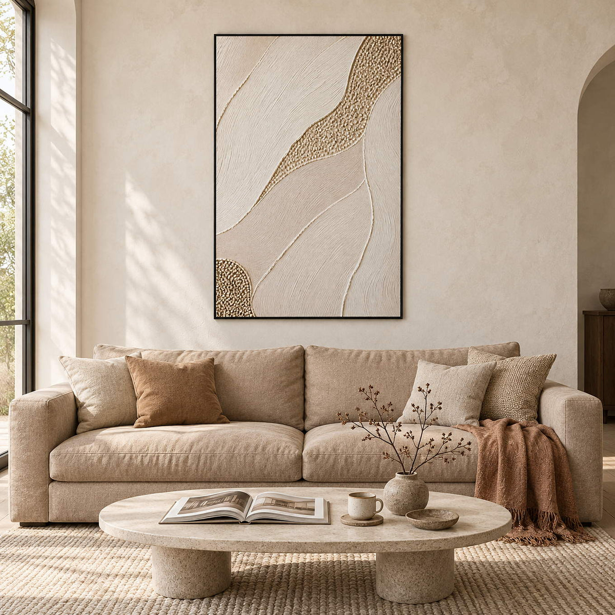 Ivory relief painting with flowing grooves and a golden pebble-like path in a black frame in a living room.