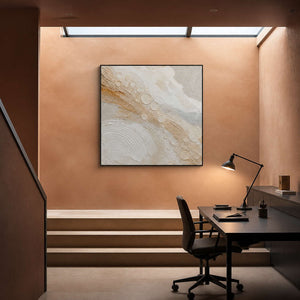 Quiet gold orbits across ivory wall art in a contemporary home office.