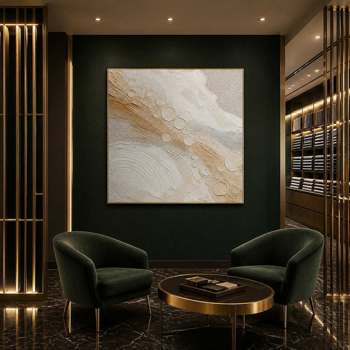 Quiet gold orbits across ivory wall art in a contemporary hospitality lounge.