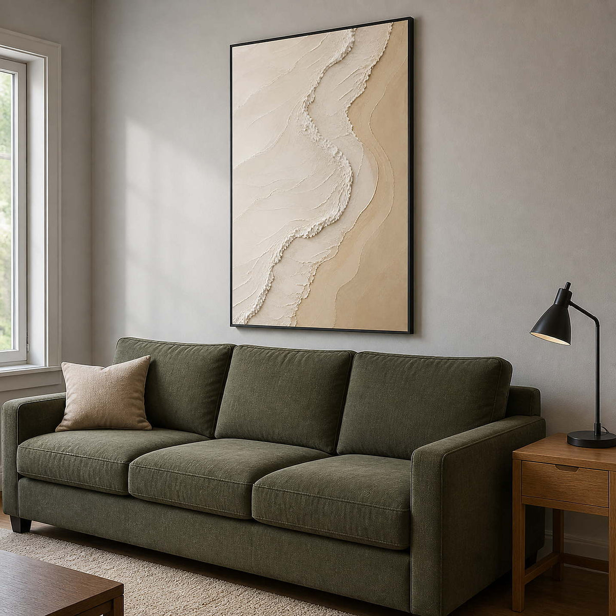 Warm sand and cream wall art above an olive family room sofa.