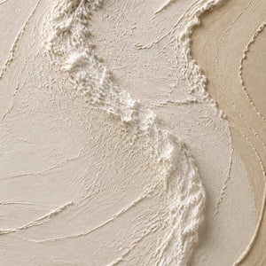 Close-up of raised ivory ridges and layered warm sand paint texture.