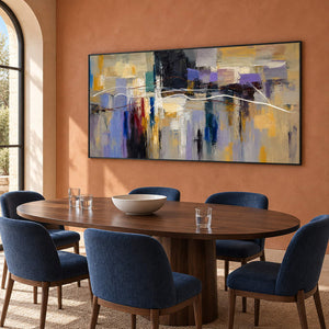 Hand-painted textured abstract wall art in golden ochre, smoky violet, slate blue, and charcoal, displayed in a dining room in a black frame.