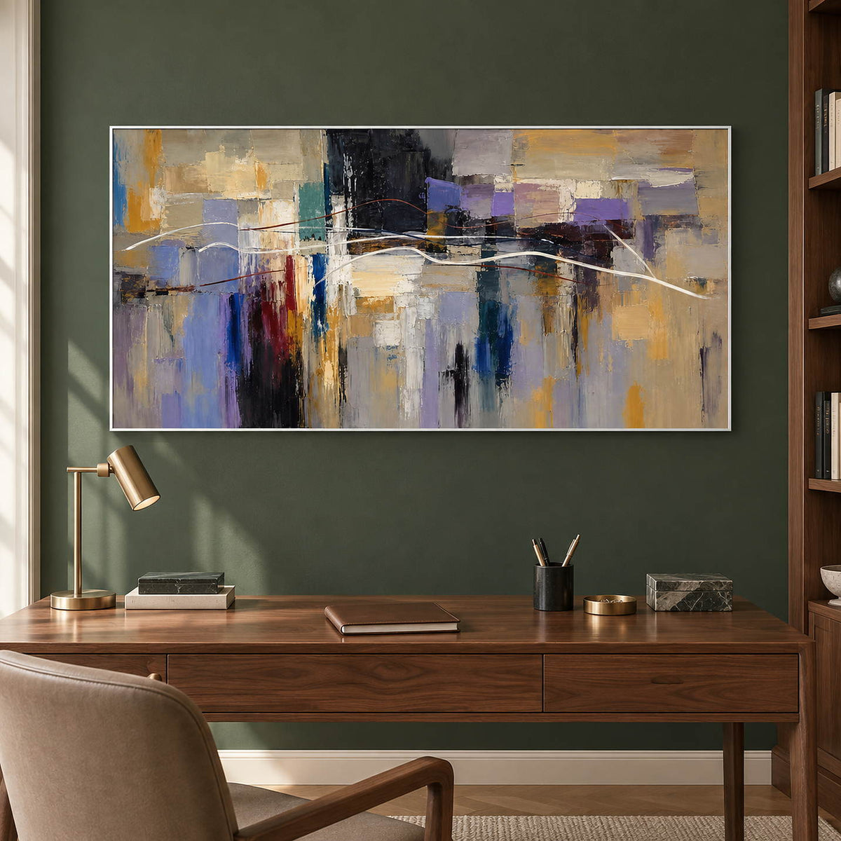 Hand-painted textured abstract wall art in golden ochre, smoky violet, slate blue, and charcoal, displayed in a study in a white frame.