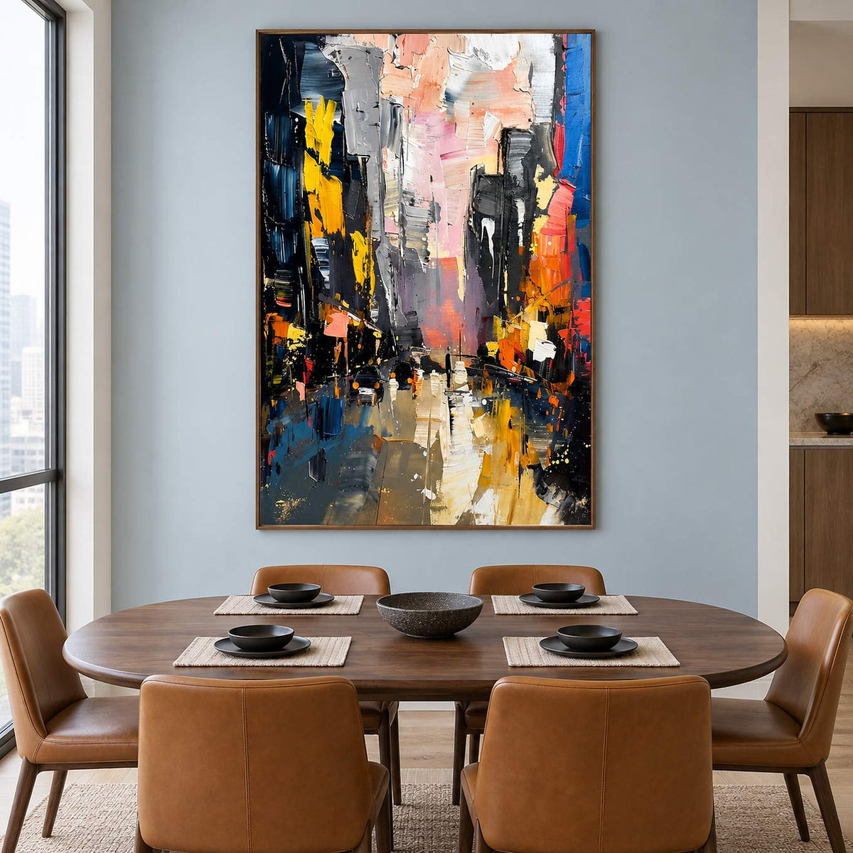 Textured rainy city street painting with yellow lights and dark buildings in a brown wood frame in a dining room.