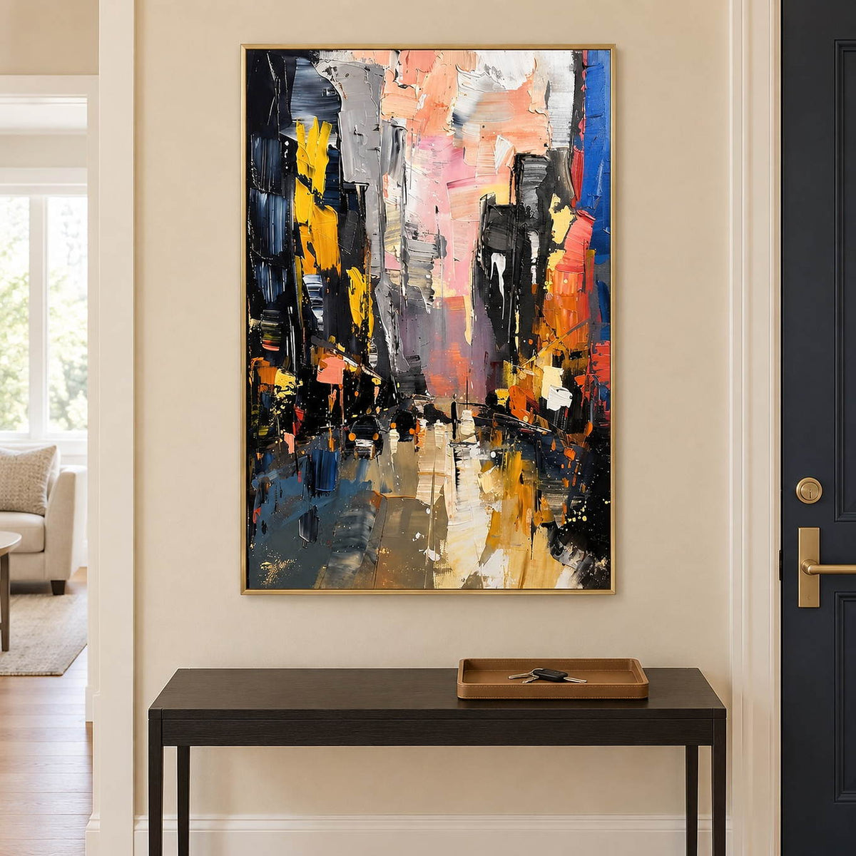 Textured rainy city street painting with yellow lights and dark buildings in a gold frame in an entryway.