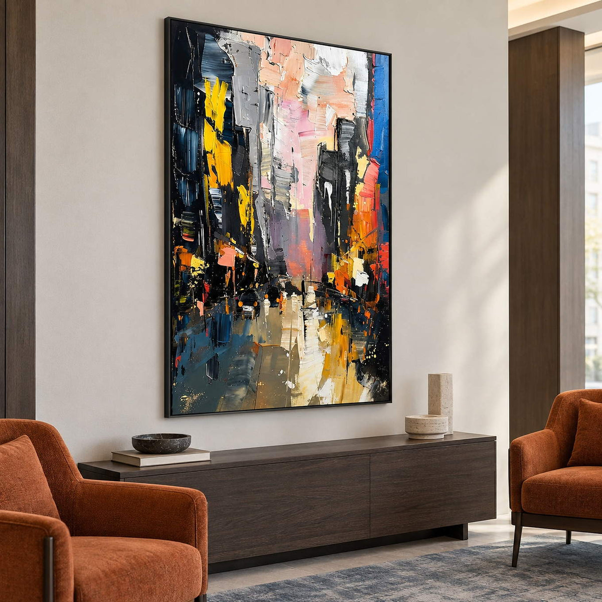 Textured rainy city street painting with yellow lights and dark buildings in a black frame in a reception lounge.