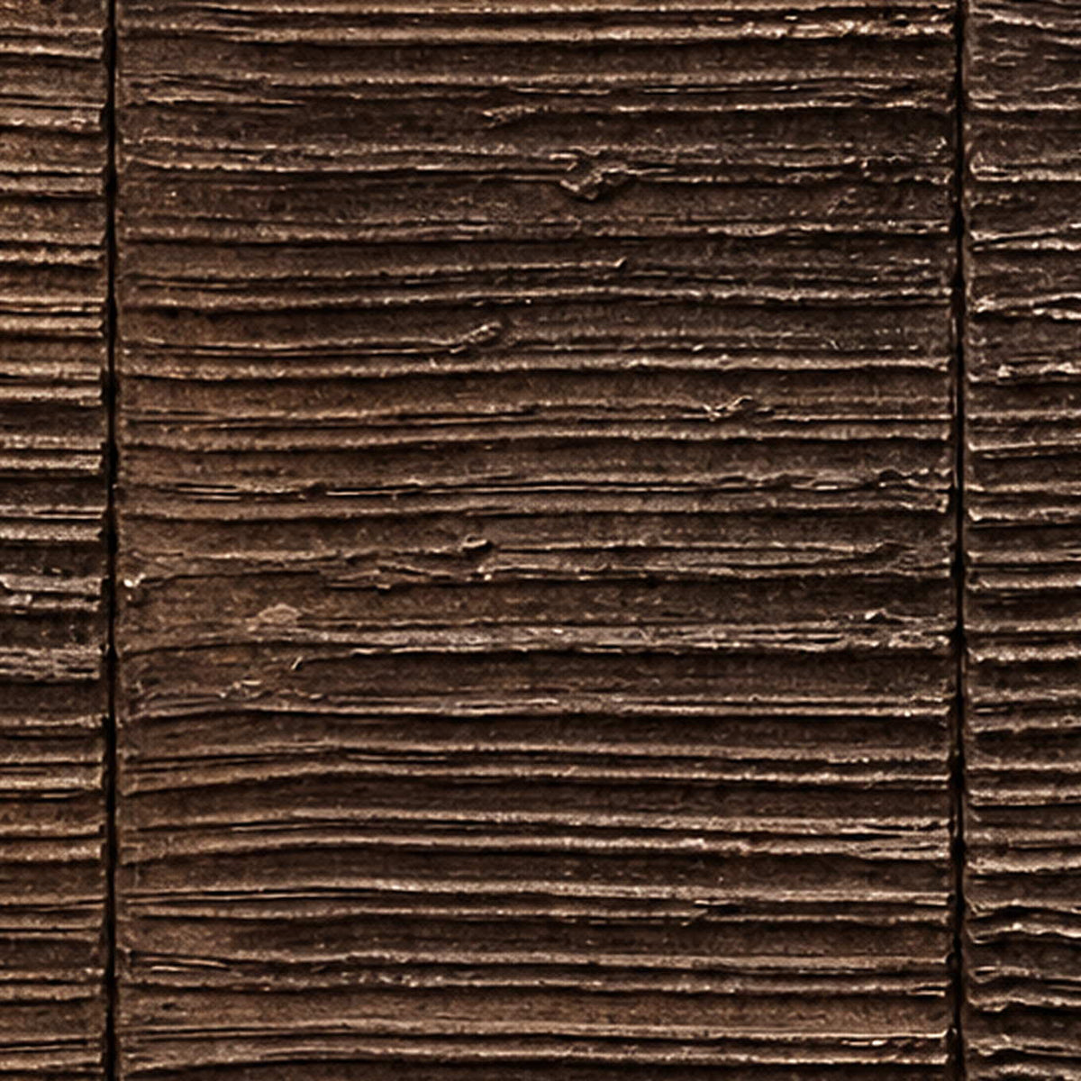Close view of fine brown relief ridges with uneven edges and dark recesses.