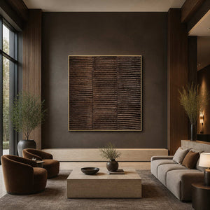 Gold framed square ridged artwork above lounge seating in a hotel lobby.