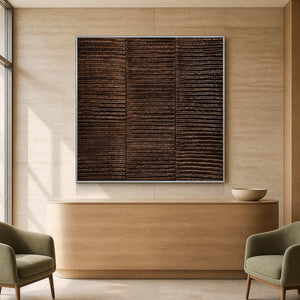 Silver framed brown textured painting behind a curved wooden wellness reception desk.