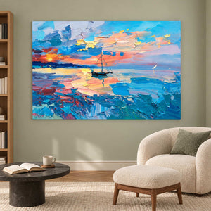 Sailboat seascape beside a cream reading chair and ottoman.
