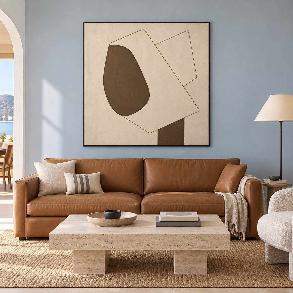 Hand-painted square canvas with cream planes and one rounded brown form, displayed in a living room in a black frame.