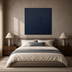 Deep blue geometric wall art in a calm neutral bedroom.