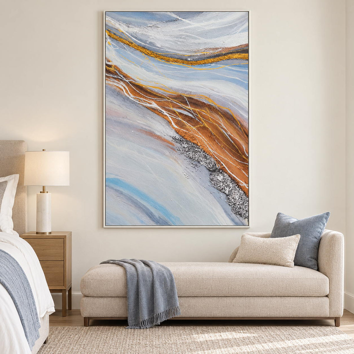 Pale blue-gray bands curving around ochre areas with fine white lines in an artwork with a white frame, displayed in a bedroom near the bed.