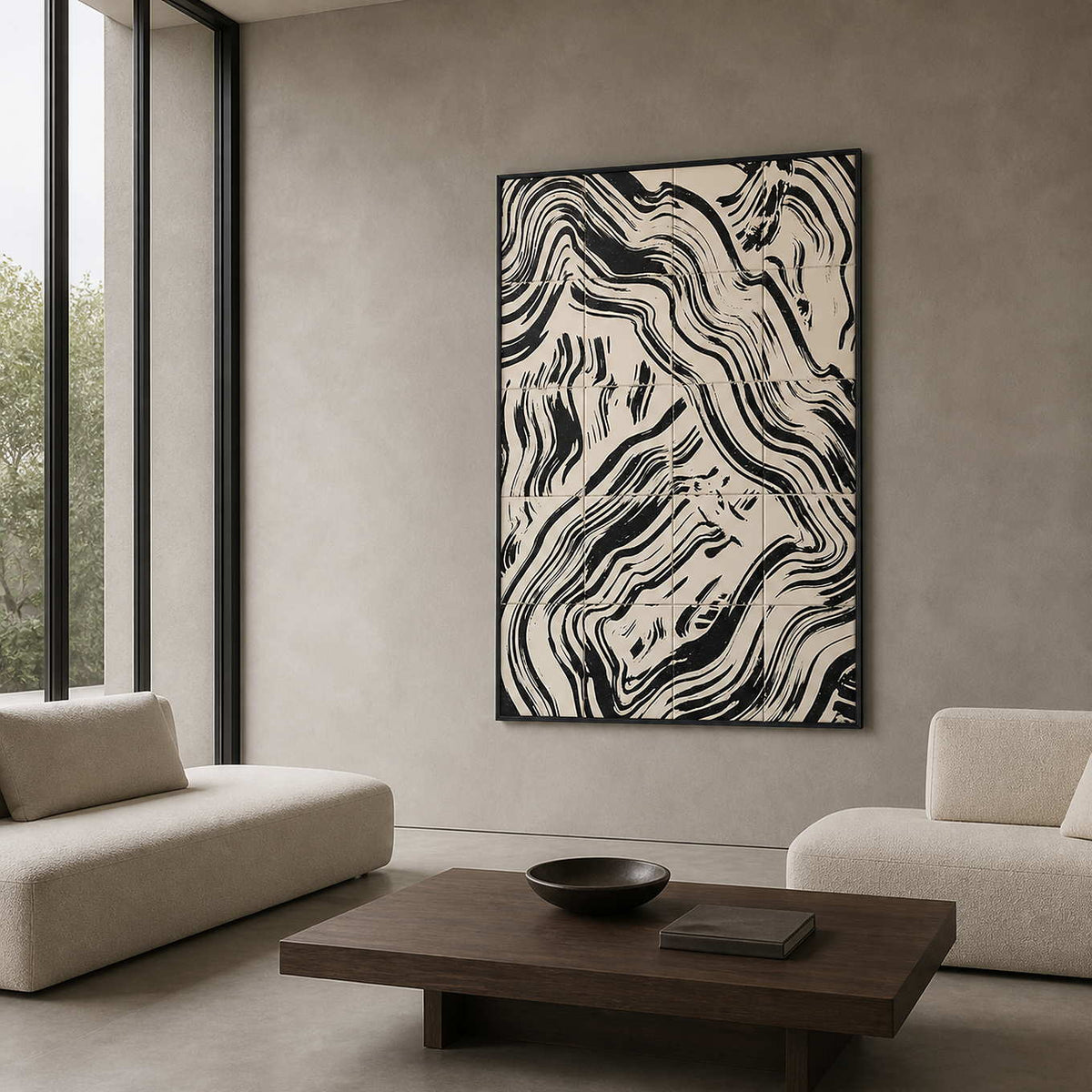 Black framed abstract painting with curved bands beside seating in a design studio lounge.