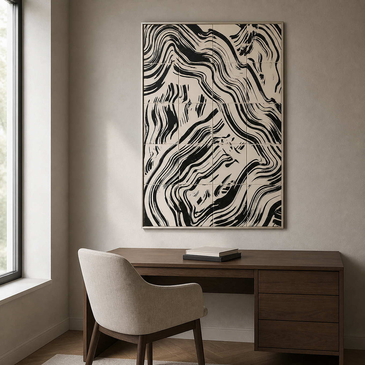 Silver framed abstract painting with flowing black lines above a home office desk.