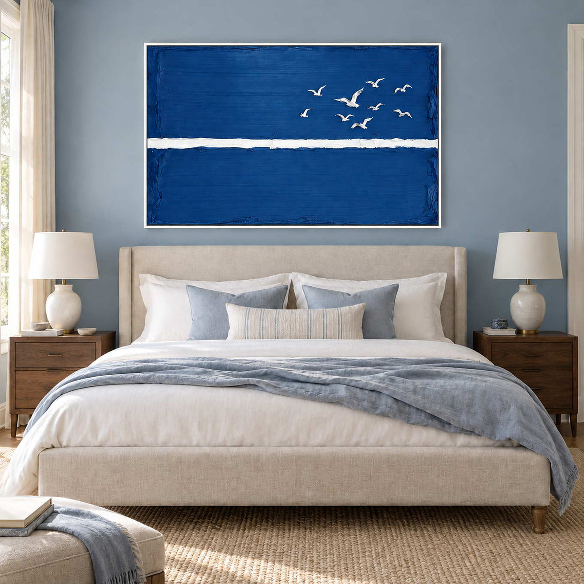 Room to Fly in a white frame above a cream bed with soft blue bedding against a blue-gray wall.