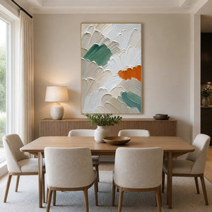 Sage and orange abstract canvas warms a refined neutral dining room.