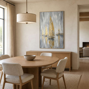 Gold sailboat artwork displayed above an elegant neutral dining room.