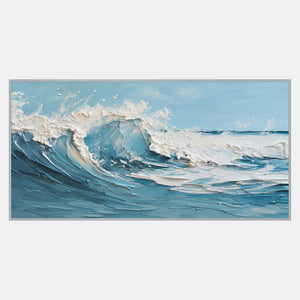 Horizontal seascape of a curling blue wave with thick white foam and spray under a pale blue sky.