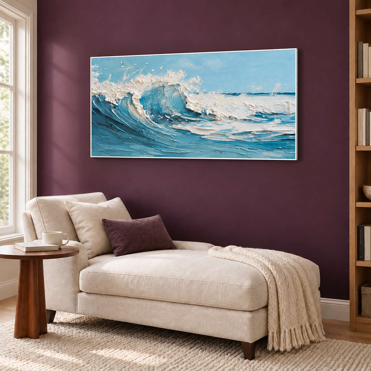 Wide wave painting above a cream chaise against a burgundy wall.