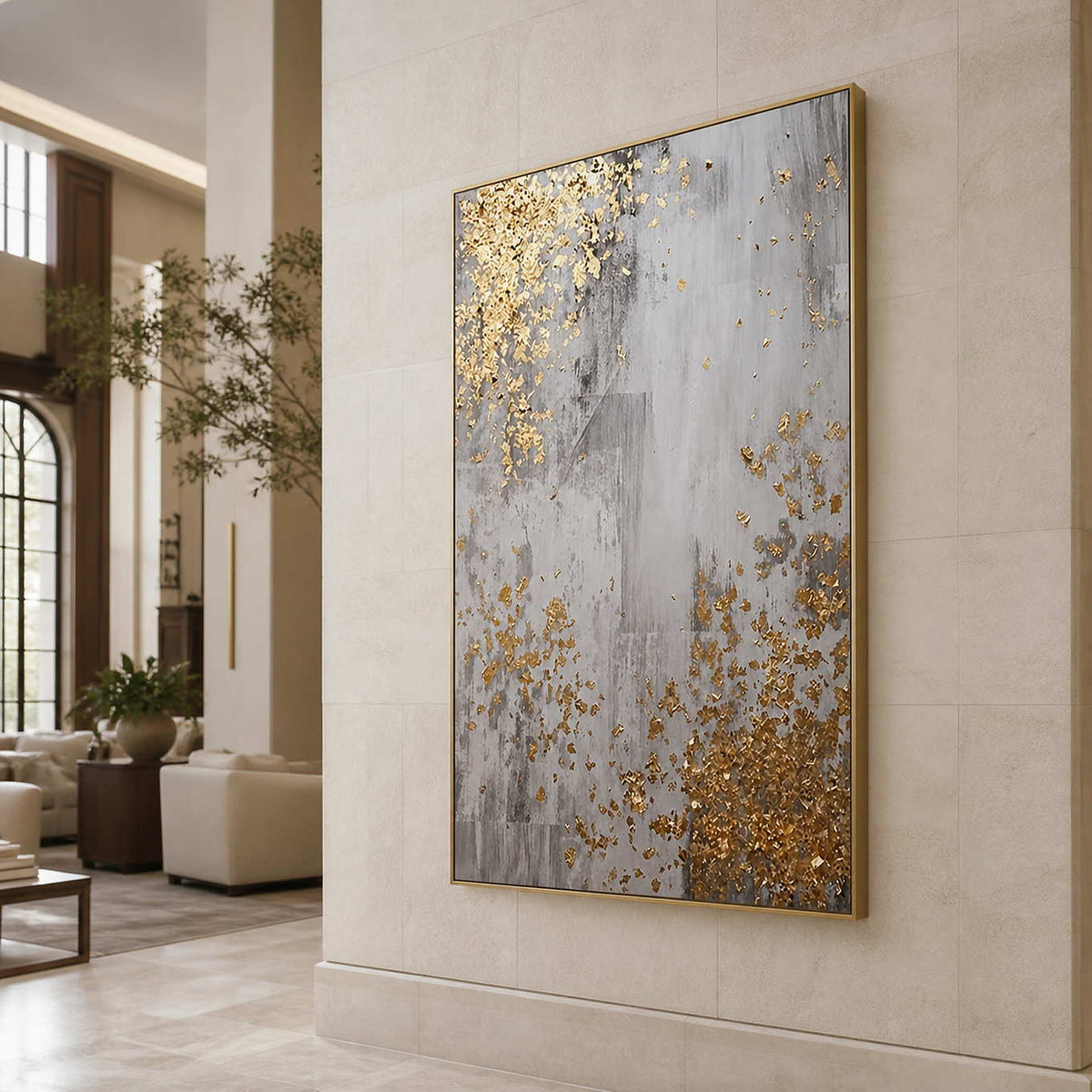 Gold framed gray abstract artwork on a stone wall overlooking hotel lounge seating.