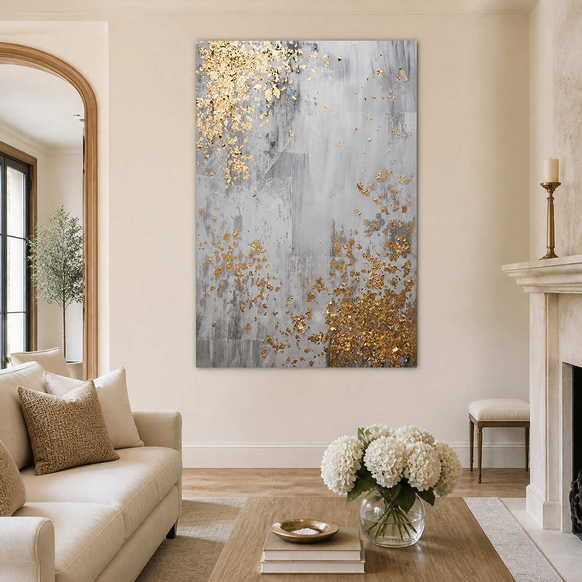 Frameless gray abstract artwork with gold flecks beside a cream living room sofa.