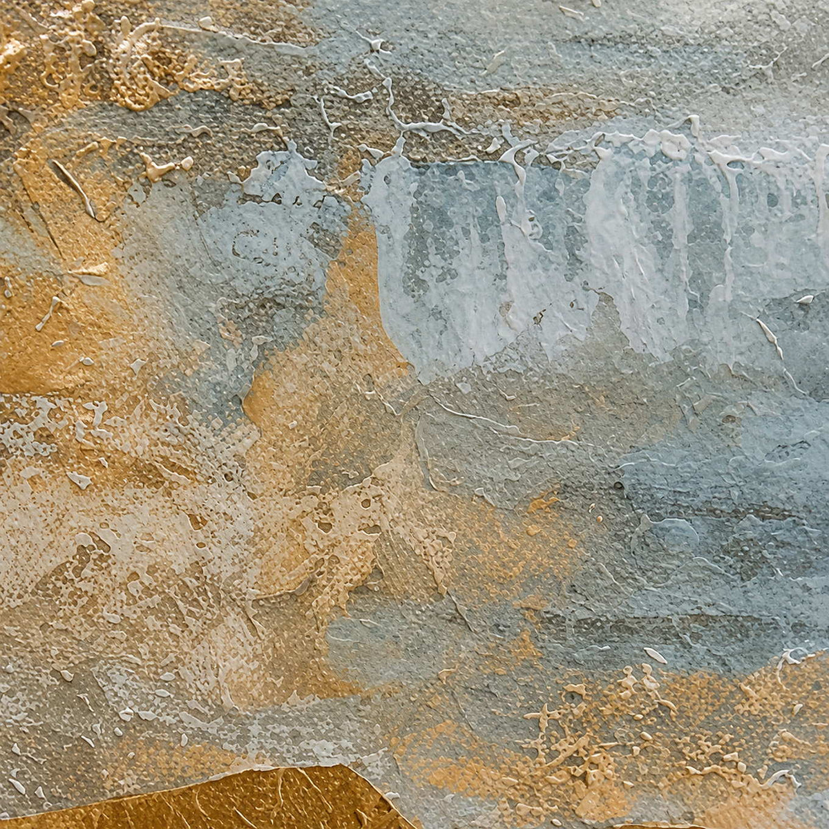 Close view of blue gray paint ridges and warm gold layers on textured canvas.