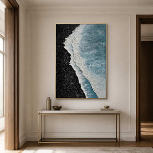 Gold framed blue and black abstract above a slim stone topped hallway console.
