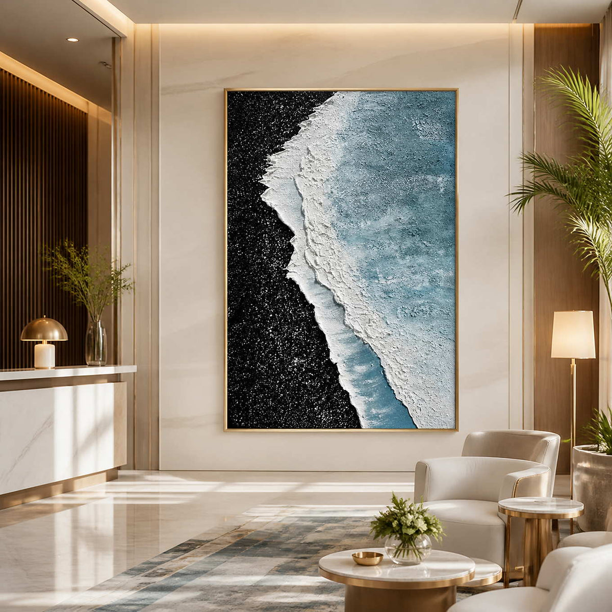 Gold framed coastal abstract artwork beside a reception desk in a bright hotel lobby.
