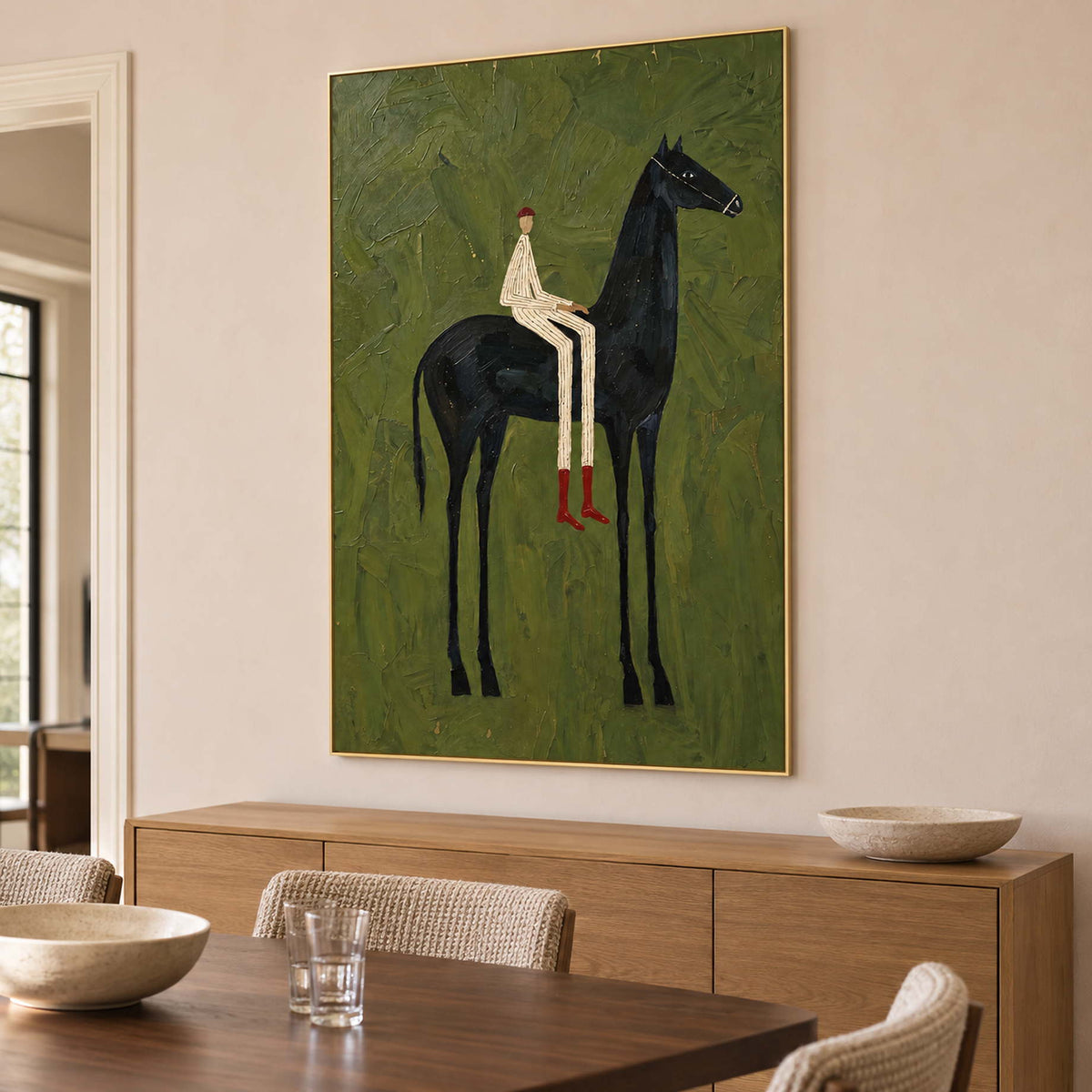 Horse-and-rider artwork above a wooden sideboard near a dining table.