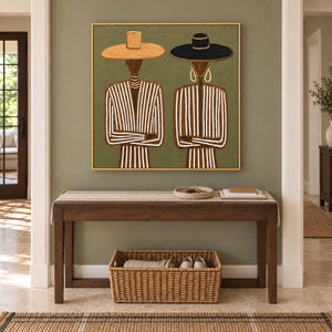 Shared Understanding in a gold frame above a dark wood console with books and a woven basket in a green hallway.