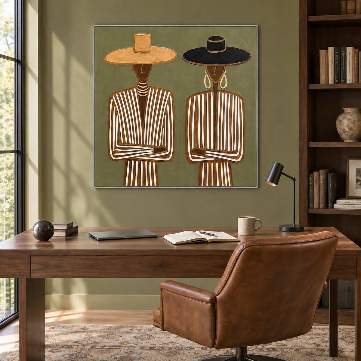 Shared Understanding in a silver frame above a dark wood desk and brown leather chair against an olive wall.