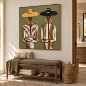 Shared Understanding in a wood frame above an olive cushioned bench with folded towels in a bathroom dry area.