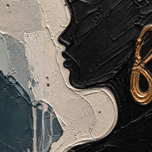 Close-up of black profile relief and a gold-copper painted earring.