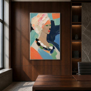 Bold coral and navy portrait wall art energizes a dark office.