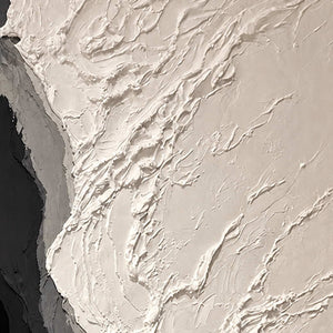 Close view of raised ivory paint ridges meeting curved gray and black layers.
