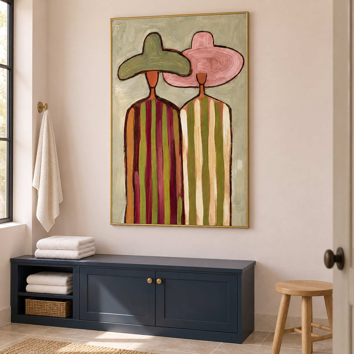 Tall striped-figure art above a blue cabinet holding folded towels.