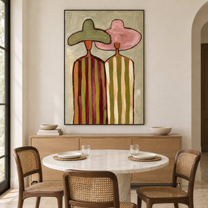 Tall hat portrait behind a round dining table with woven chairs.