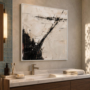 Ivory abstract painting with sweeping black marks and fine crossing lines in a white frame beside a bathroom vanity.