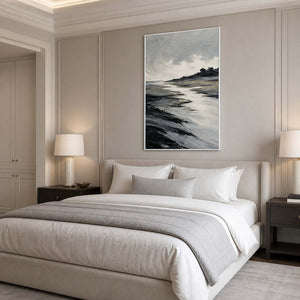 Calming black and silver seascape wall art above a bedroom with a white frame.