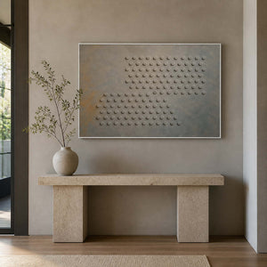 Textured abstract wall art displayed above a stone entryway console.
