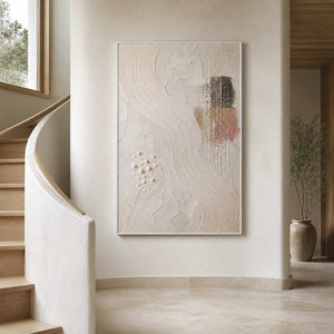 Vertical textured wall art displayed beside a warm white stairway.
