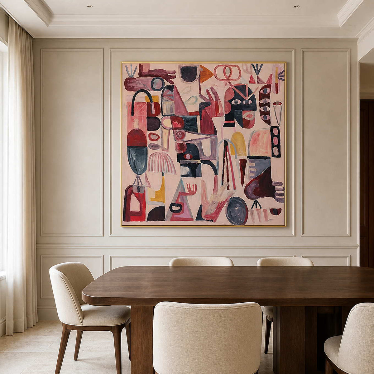 Gold framed playful pink artwork above a dining table against pale paneled walls.