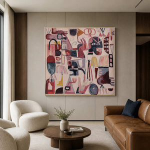 Gold framed pink abstract artwork overlooking leather and cream seating in a hotel lobby.