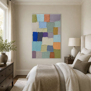 Soft blue and neutral abstract canvas above a calm modern bed.