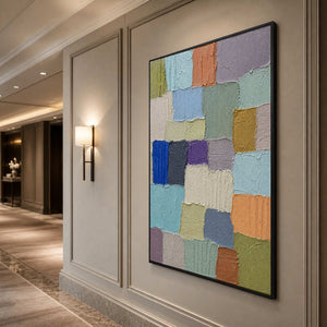 Pastel color block wall art displayed along a contemporary hallway.