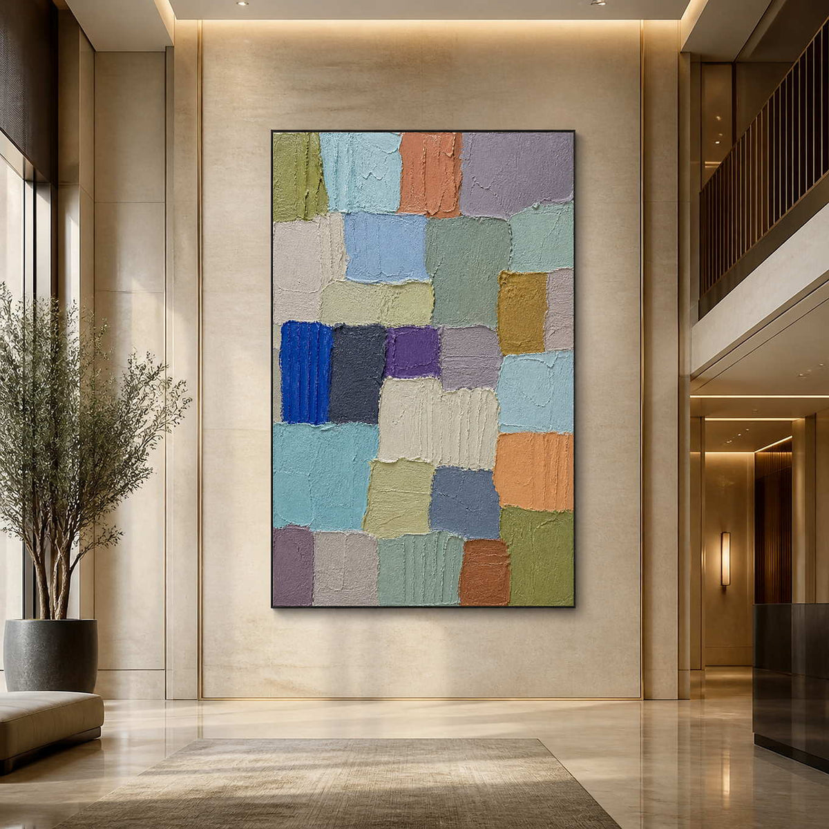 Textured color block painting displayed in a spacious contemporary hotel lobby.