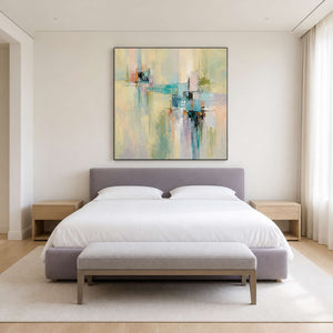 Soft colorful abstract canvas centered above a calm modern bed.