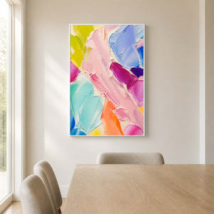 Pastel textured wall art bringing playful color to a light modern dining room.