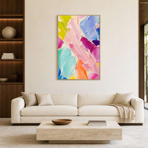 Colorful textured abstract wall art displayed above a bright neutral living room sofa.